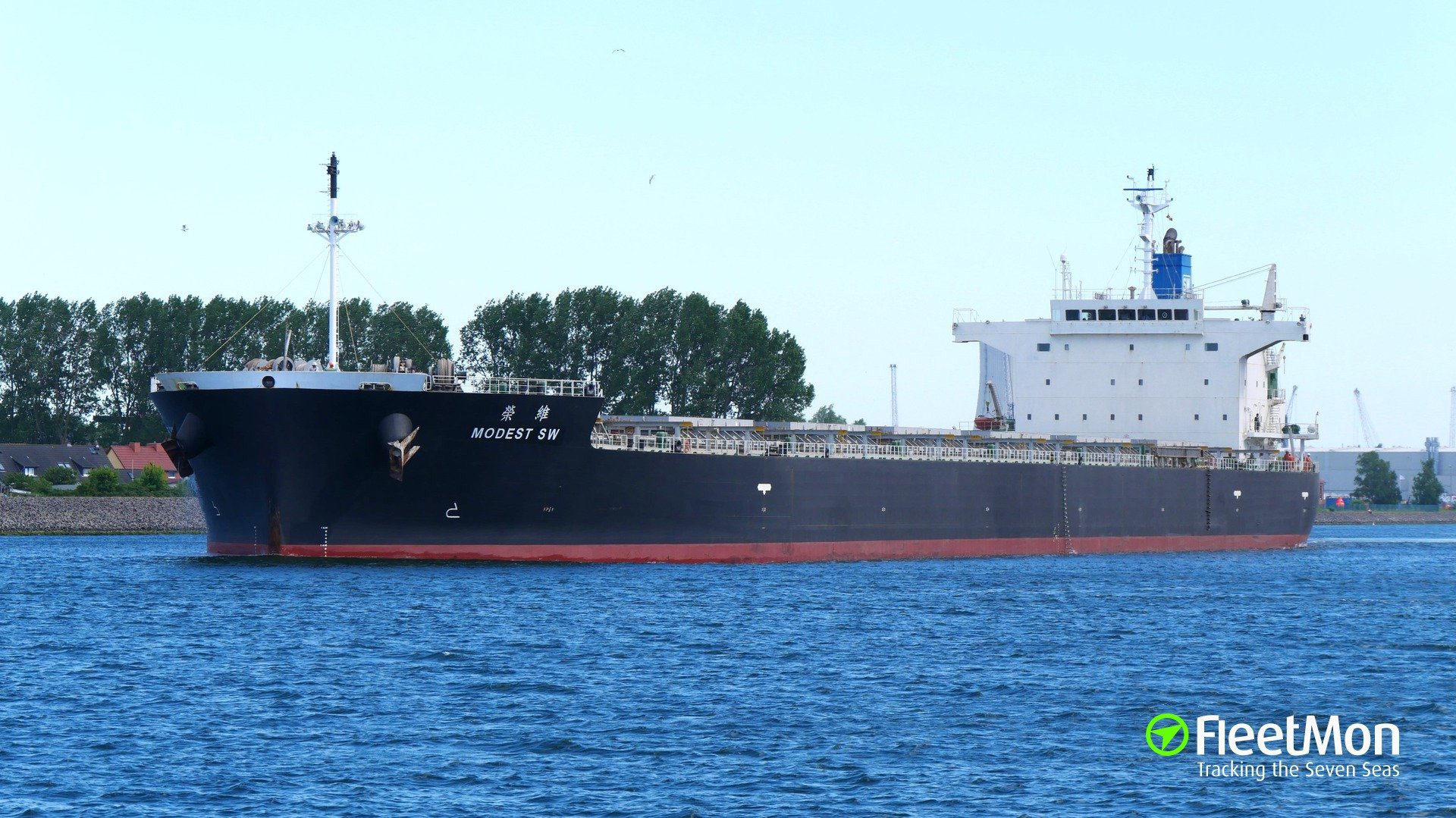 Modern cargo vessel navigating across the ocean